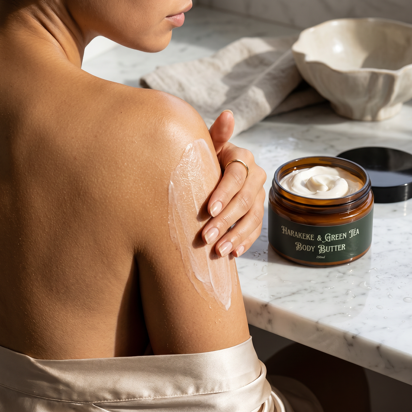 Woman applying thin layer of Luid Leef Harakeke & Green Tea Body Butter to her upper arm.