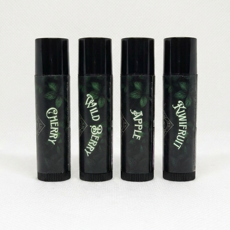 Lucid Leef lip balm collection with labels showing the flavours in the range. Cherry, Wild Berry, Apple and Kiwifruit.