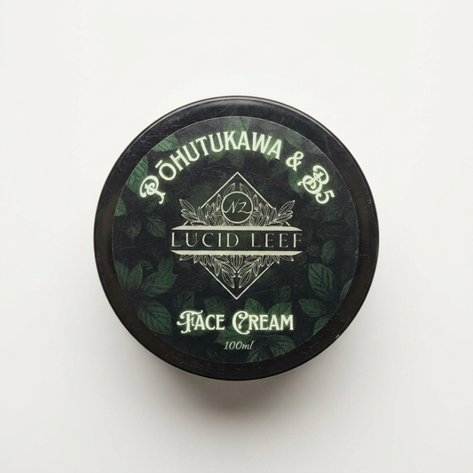 A flat lay of a pot of Lucid Leef Pōhutukawa and B5 Face Cream on a stark white studio background.